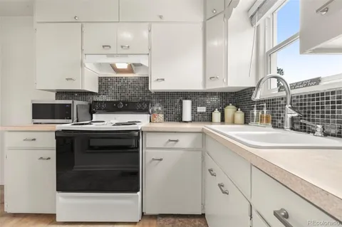 a kitchen with a sink stove and cabinets