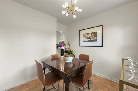 a view of a dining room with furniture and chandelier