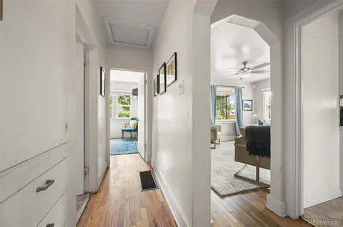 a view of a hallway view with wooden floor and furniture