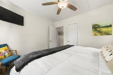 a bedroom with a bed and a flat screen tv