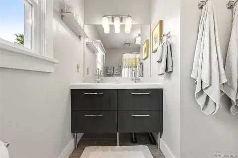 a bathroom with a sink vanity and a mirror