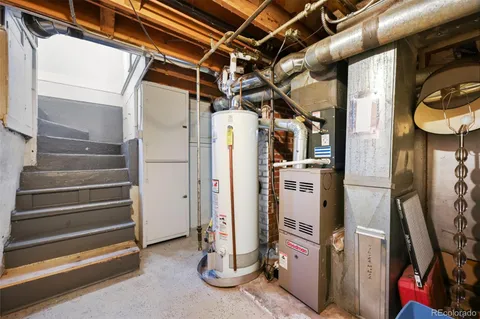 a view of an empty room with wooden floor and windows