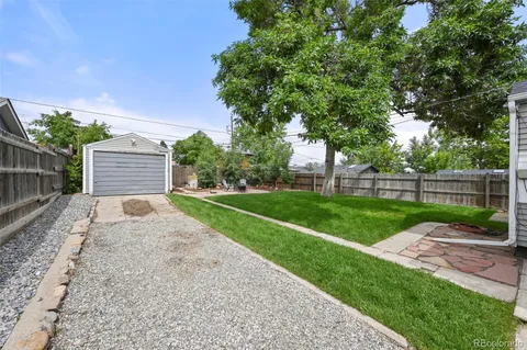 a view of a backyard with a garden and entertaining space