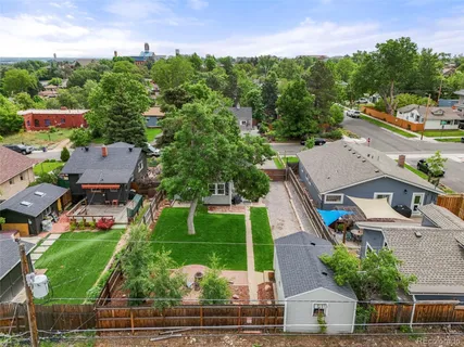 an aerial view of a house with a garden and lake view