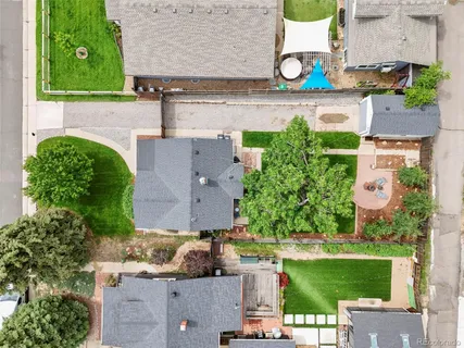 an aerial view of a house with a yard and a fountain