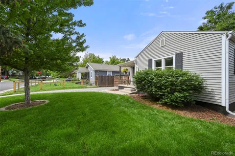 a front view of a house with a yard and trees