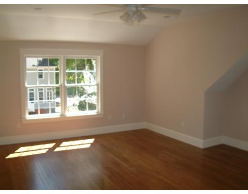 7 Dee Road Lexington, MA 02420 - Photo 9 of 12 an empty room with wooden floor and a window