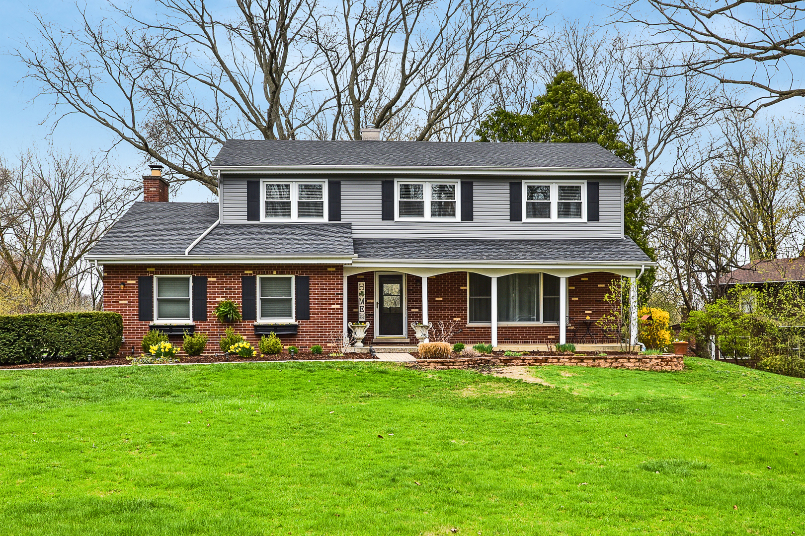 317 Roberts Road Inverness, IL 60067 - Photo 1 of 20 a front view of a house with garden and outdoor seating