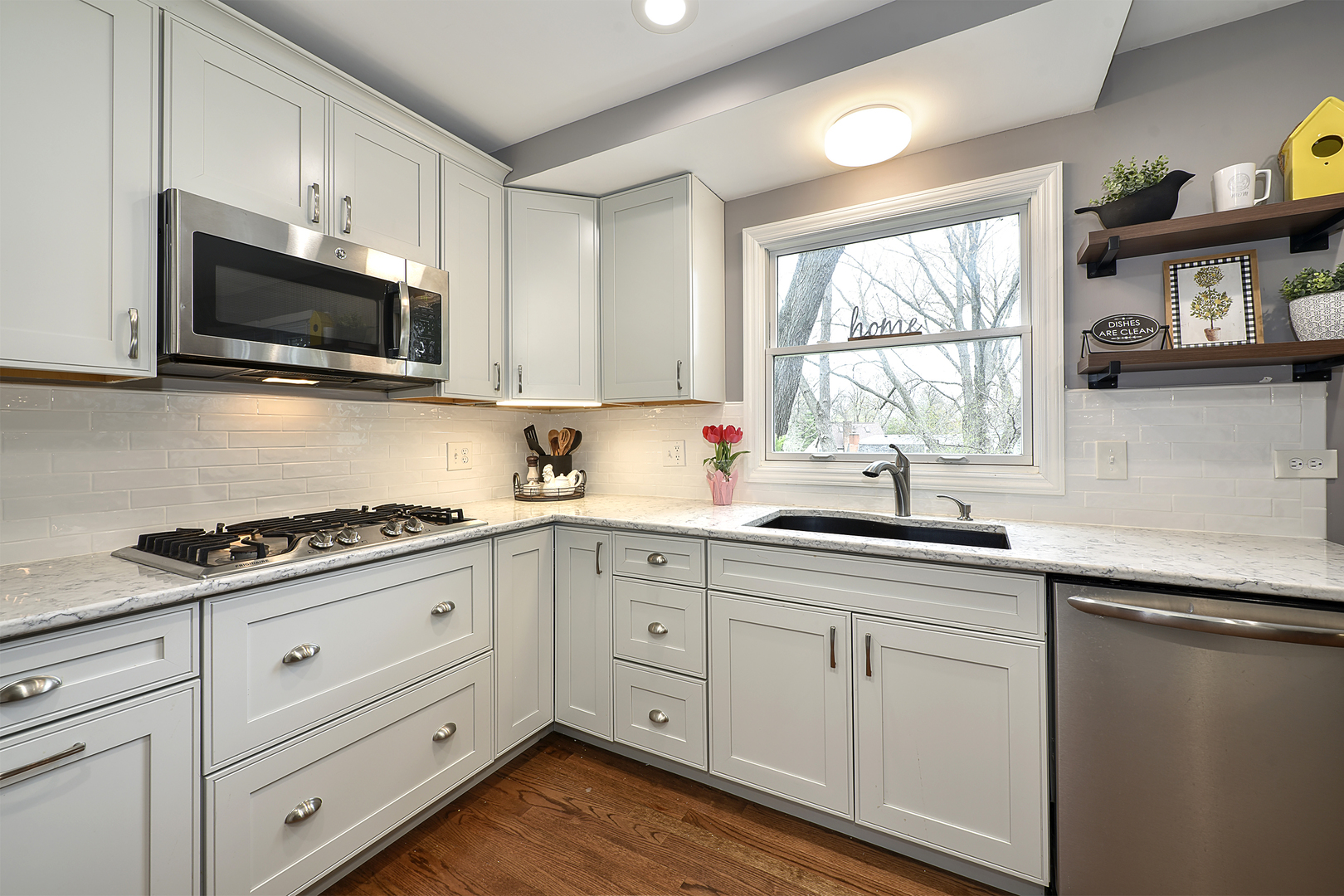 317 Roberts Road Inverness, IL 60067 - Photo 3 of 20 a kitchen with white cabinets stainless steel appliances and window