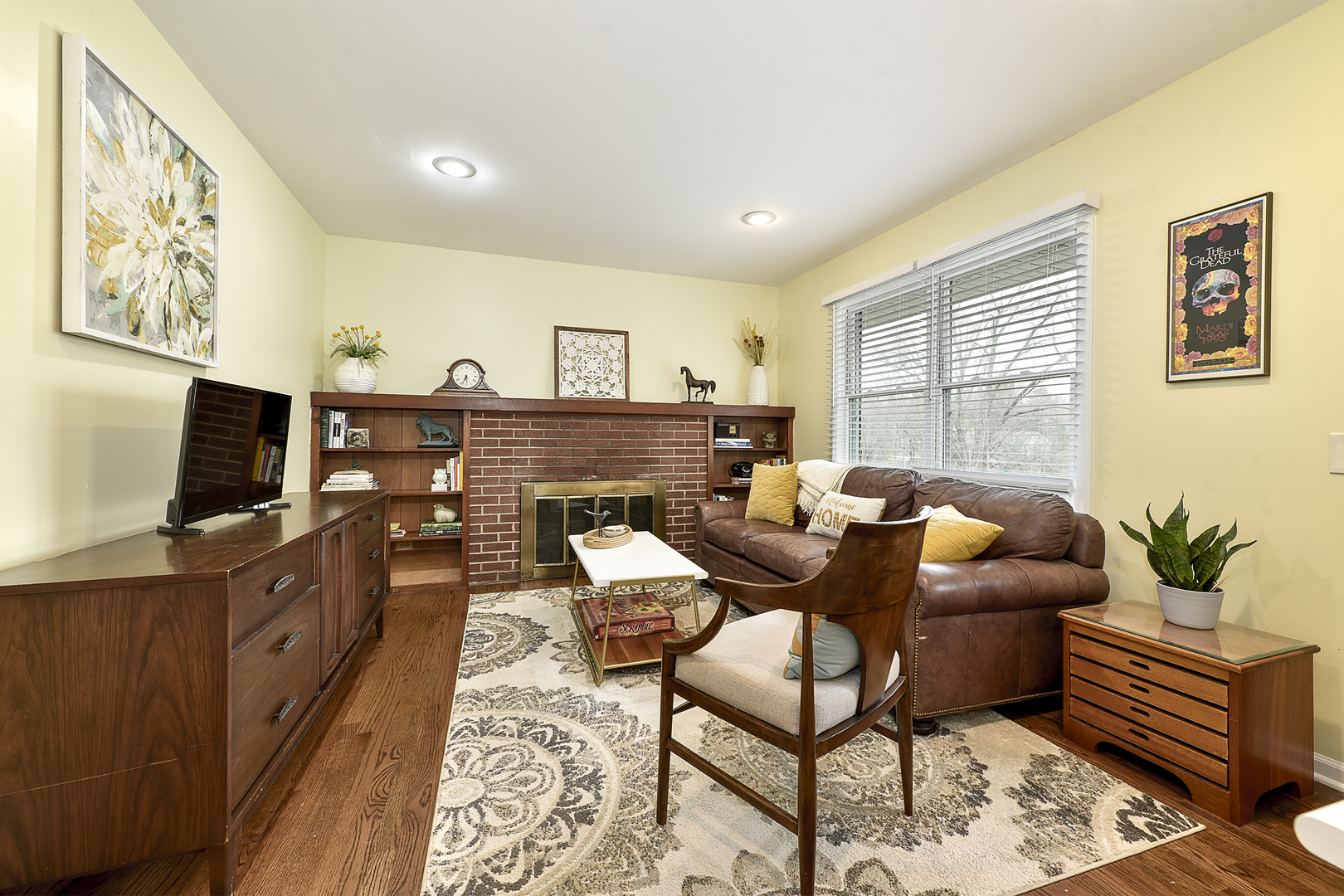317 Roberts Road Inverness, IL 60067 - Photo 8 of 20 a living room with furniture a flat screen tv and a fireplace
