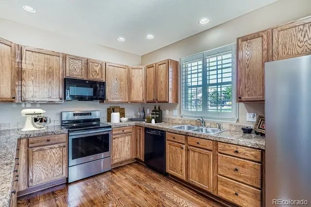 a kitchen with a refrigerator a sink and a window