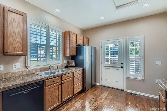 a kitchen with stainless steel appliances granite countertop white cabinets sink stove and microwave