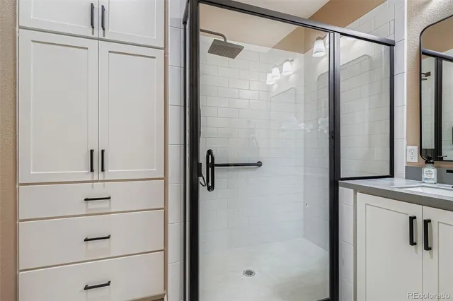 a view of a livingroom with lounge chair and windows