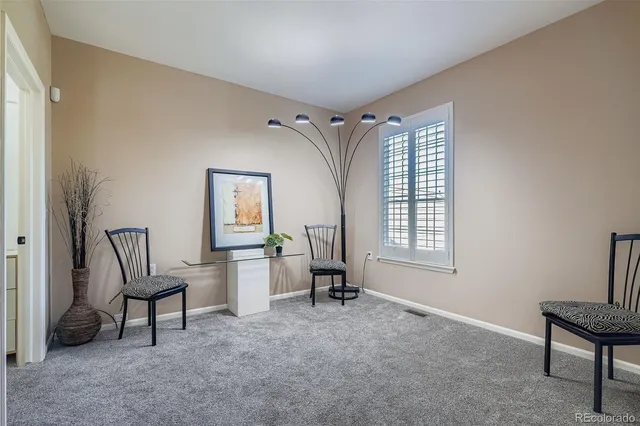 a bed room with a bed and a painting on the wall