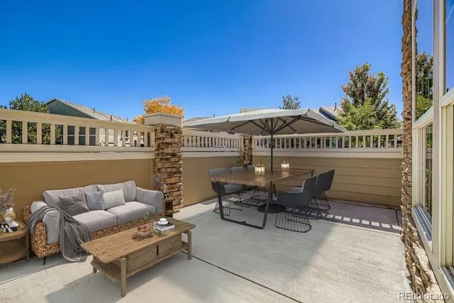 a view of a house with a barbeque and wooden stairs
