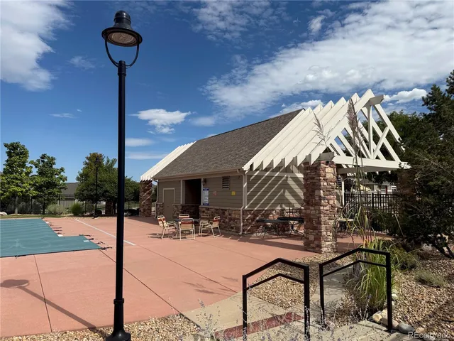 a backyard of a house with table and chairs