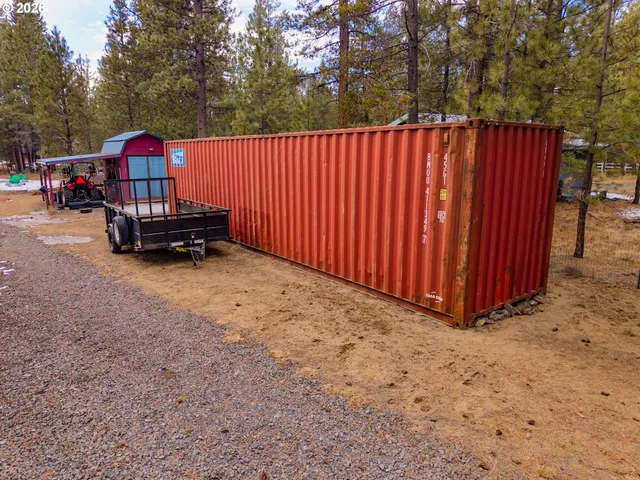 a view of a house with wooden fence