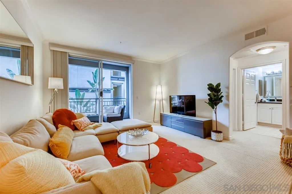 9263 Regents Road, Unit B203 La Jolla, CA 92037 - Photo 1 of 25 a living room with furniture and a flat screen tv