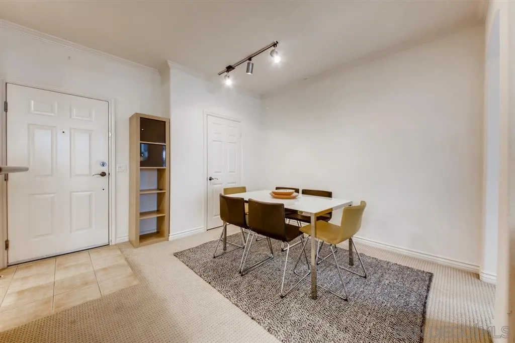 9263 Regents Road, Unit B203 La Jolla, CA 92037 - Photo 13 of 25 a table and chairs in a room