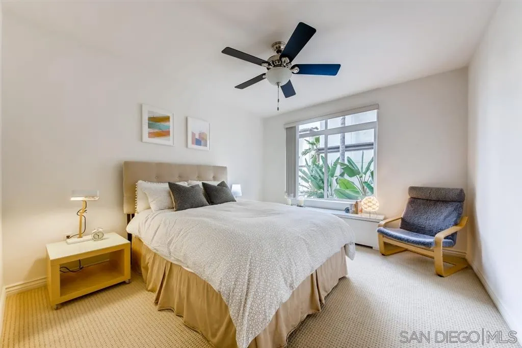 9263 Regents Road, Unit B203 La Jolla, CA 92037 - Photo 14 of 25 a bedroom with a bed and a chair