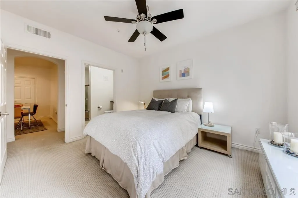 9263 Regents Road, Unit B203 La Jolla, CA 92037 - Photo 15 of 25 a bedroom with bed and a chandelier