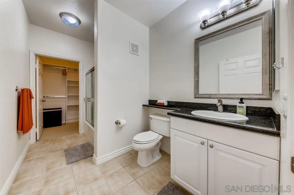 9263 Regents Road, Unit B203 La Jolla, CA 92037 - Photo 16 of 25 a bathroom with a toilet sink and mirror