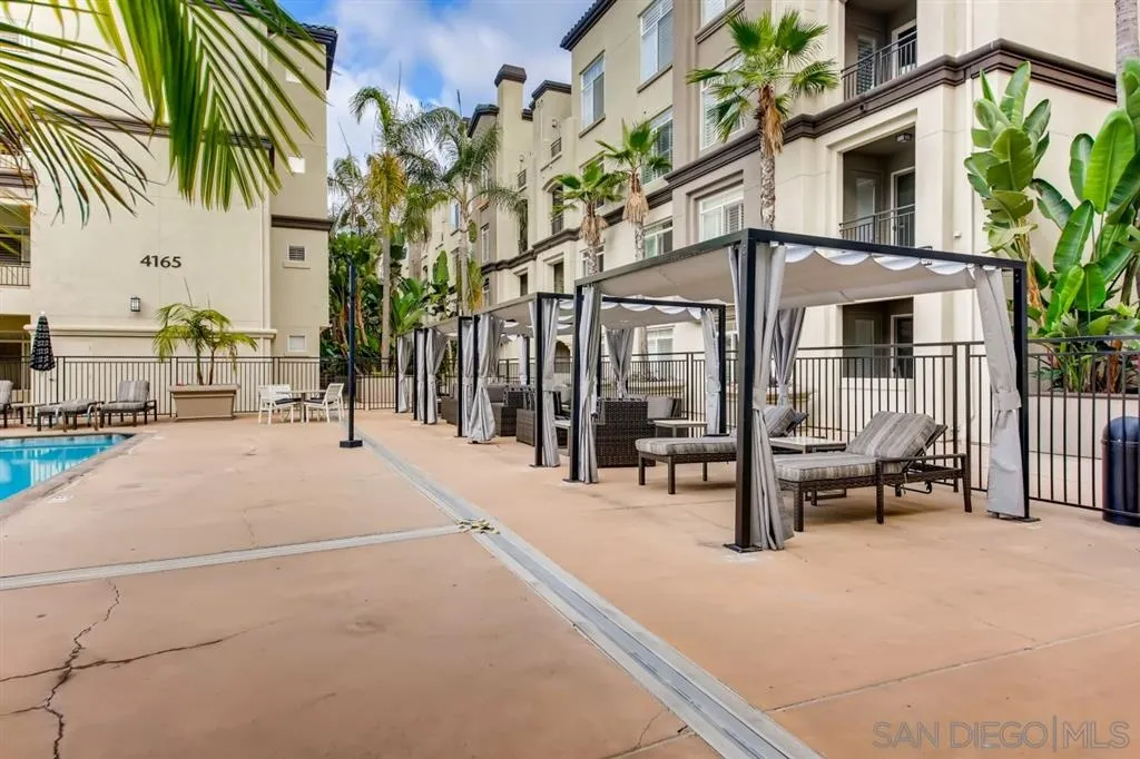 9263 Regents Road, Unit B203 La Jolla, CA 92037 - Photo 22 of 25 a building with glass door and outdoor space