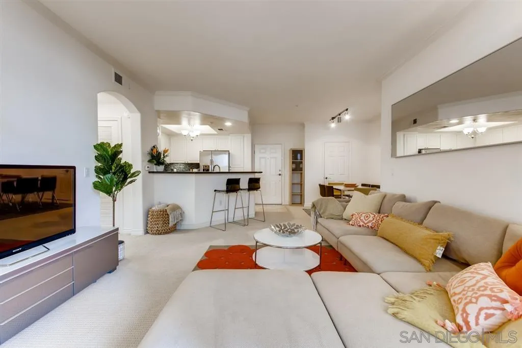 9263 Regents Road, Unit B203 La Jolla, CA 92037 - Photo 4 of 25 a living room with furniture and a flat screen tv