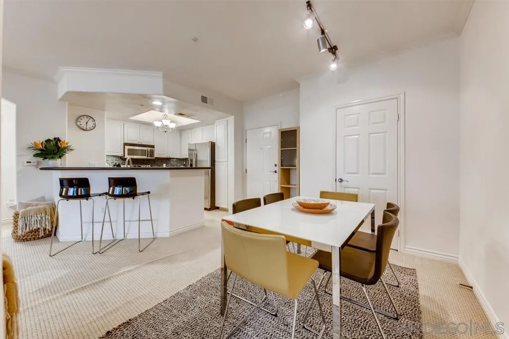 9263 Regents Road, Unit B203 La Jolla, CA 92037 - Photo 8 of 25 a kitchen with a table and chairs in it