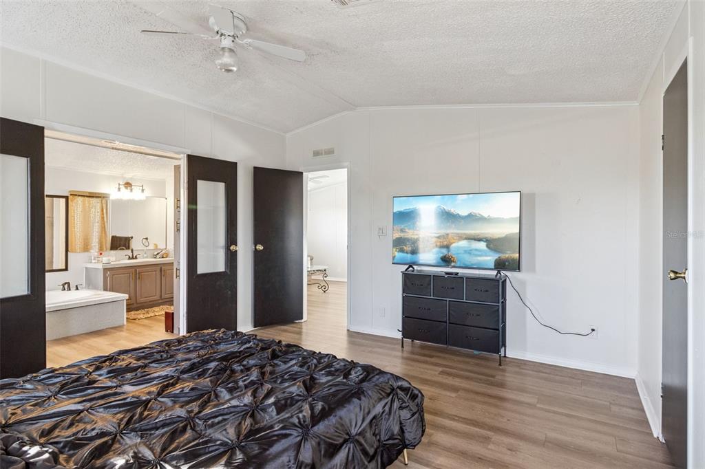1477 Alford Road Haines City, FL 33844 - Photo 17 of 41 a bedroom with a bed and a view of bathroom
