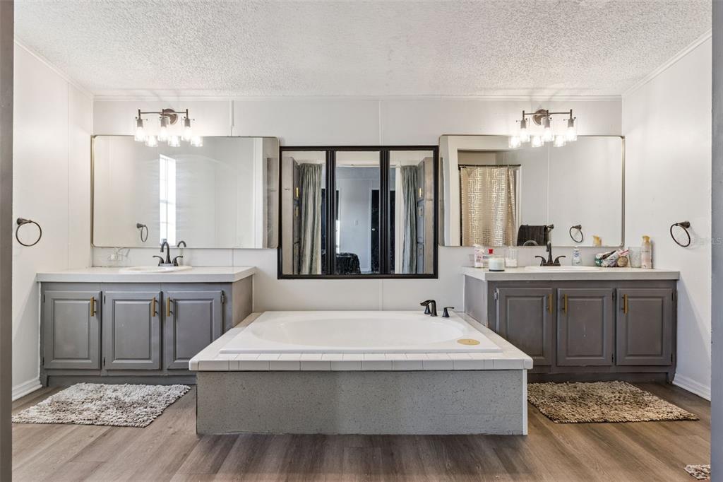 1477 Alford Road Haines City, FL 33844 - Photo 23 of 41 a spacious bathroom with a tub sink and mirror