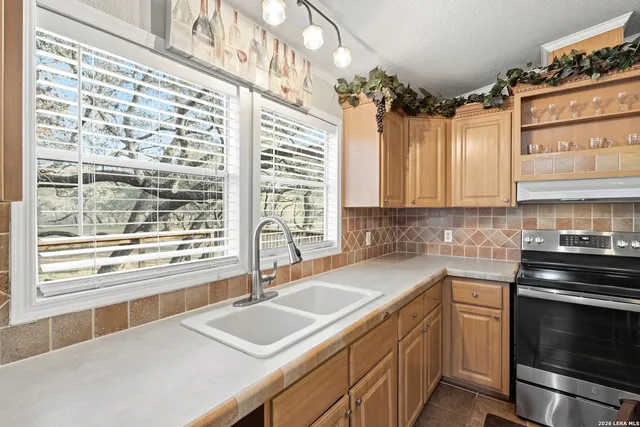 a kitchen with a sink stove and cabinets