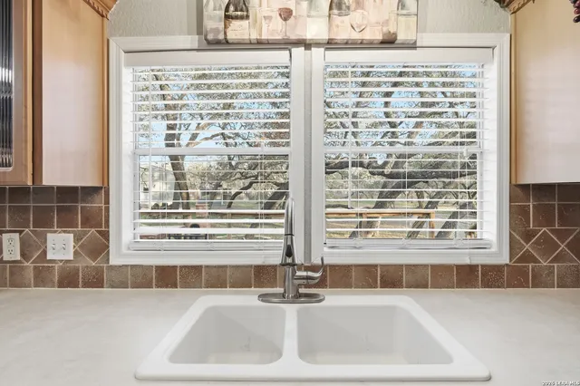 a bathroom with a bathtub and a window