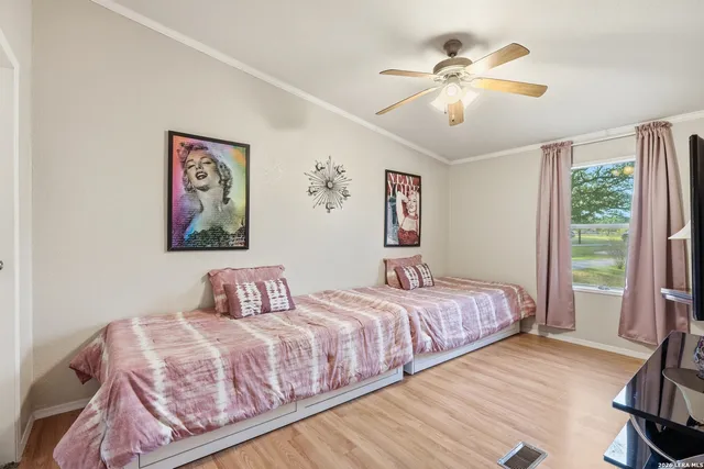 a bedroom with a large bed and a chandelier