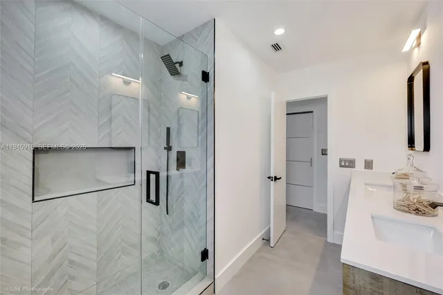a bathroom with a shower sink and mirror