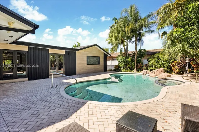 a view of outdoor space with swimming pool and seating