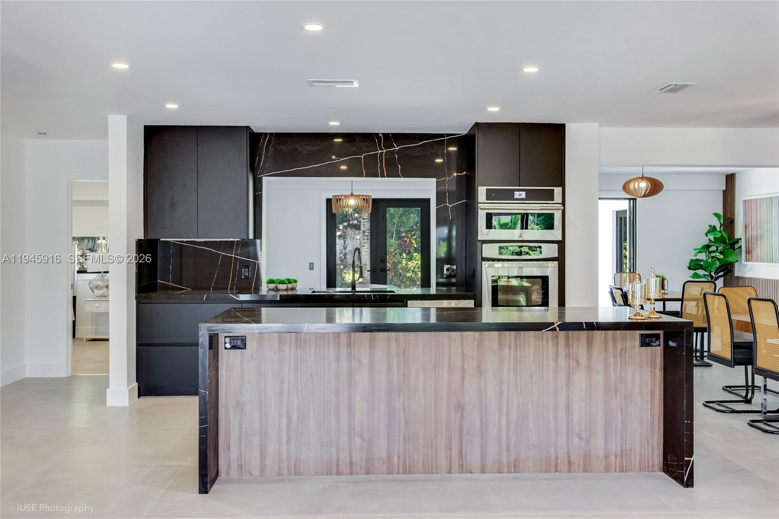 1925 Northeast 208th Terrace Miami, FL 33179 - Photo 6 of 25 a kitchen with stainless steel appliances kitchen island granite countertop a refrigerator and a stove top oven