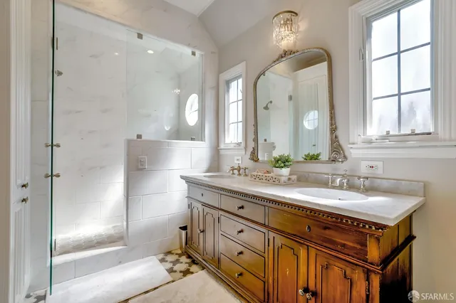 a spacious bathroom with a shower sink and mirror