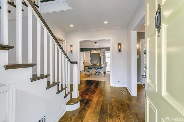 a view of entryway and hall with wooden floor