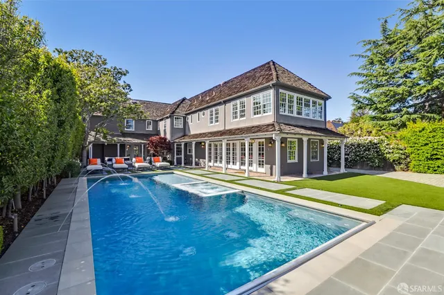 a front view of a house with a garden and patio