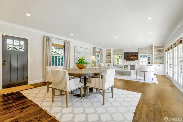 a view of a dining room with furniture and wooden floor