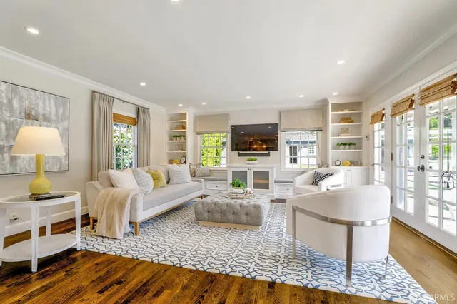 a living room with furniture and a wooden floor