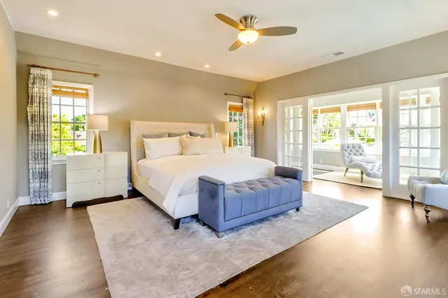 a spacious bedroom with a large bed and a chandelier