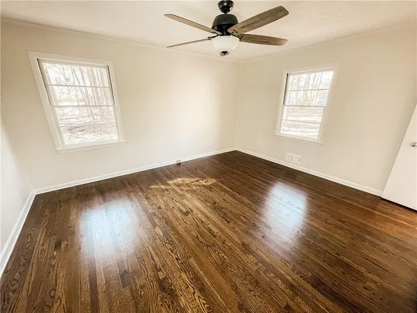 wooden floor in an empty room with a window