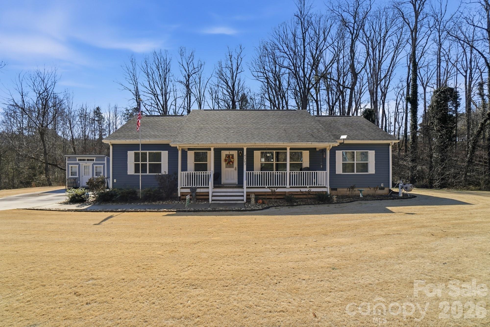 a front view of a house with a yard and trees