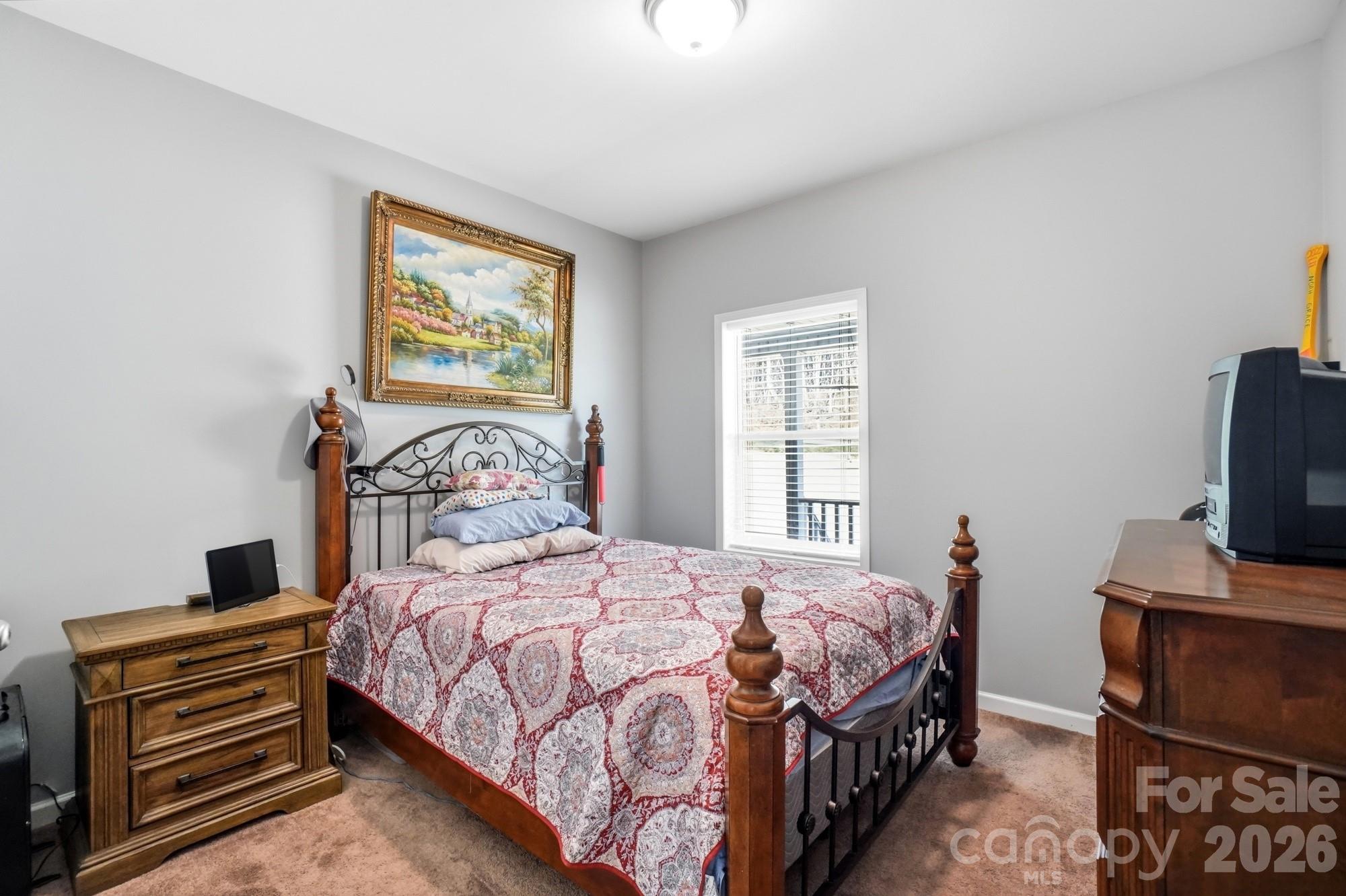 4363 Grace Church Road Newton, NC 28658 - Photo 25 of 30 a bedroom with a bed and a tv on the dresser