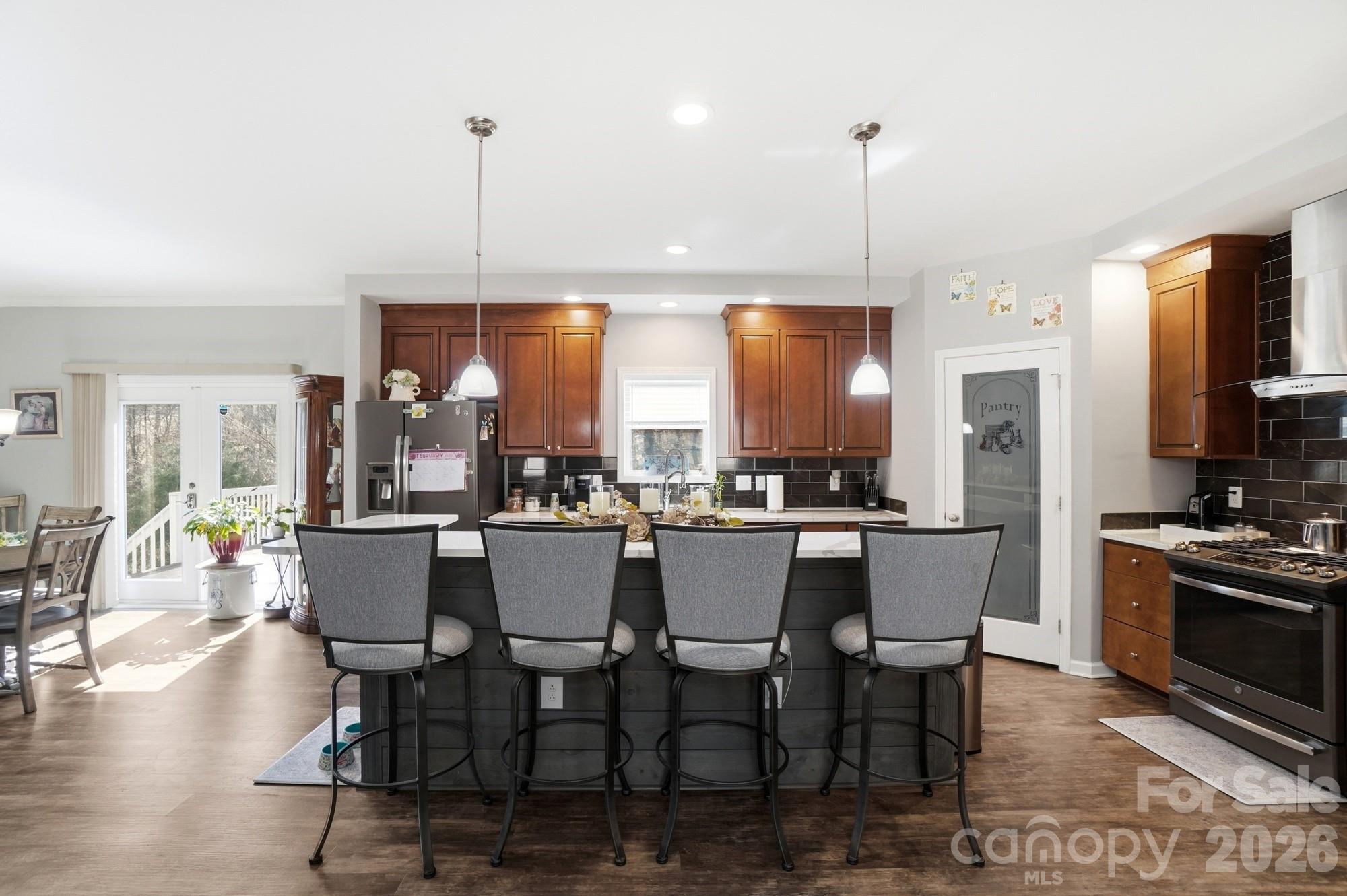 4363 Grace Church Road Newton, NC 28658 - Photo 6 of 30 a dining room with furniture a chandelier and kitchen view