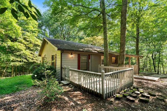 a view of a house with a small yard and wooden fence