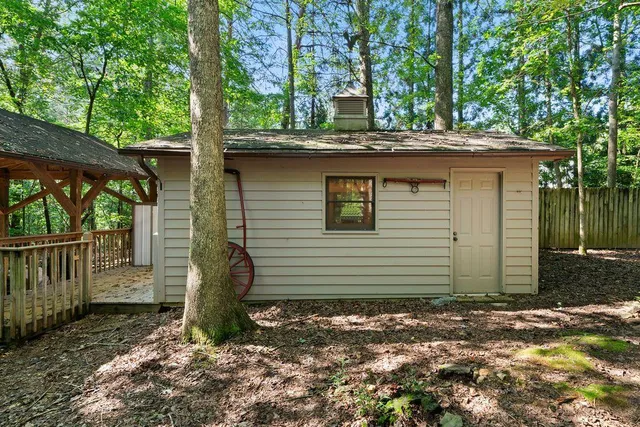 a view of a house with a tree in the background