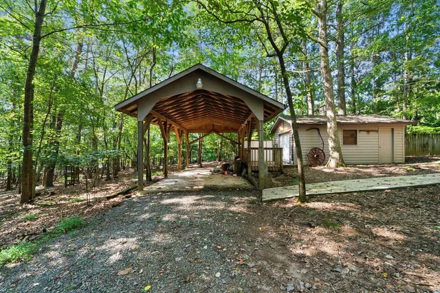 a view of a house with backyard and sitting area